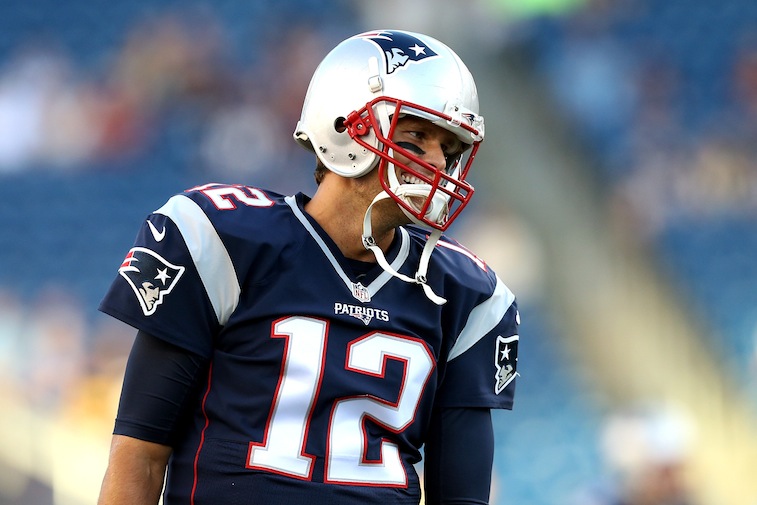 Tom Brady warms up prior to the start of a preseason game