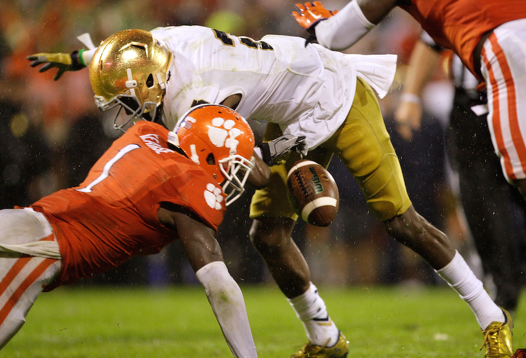 Jayron Kearse #1 of the Clemson Tigers forces a fumble against C.J. Prosise #20 of the Notre Dame Fighting Irish