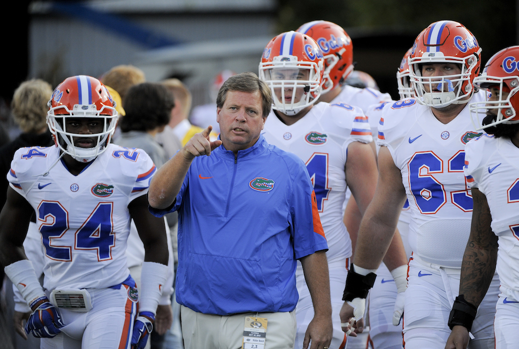 Jim McElwain leads the Florida Gators out onto the field