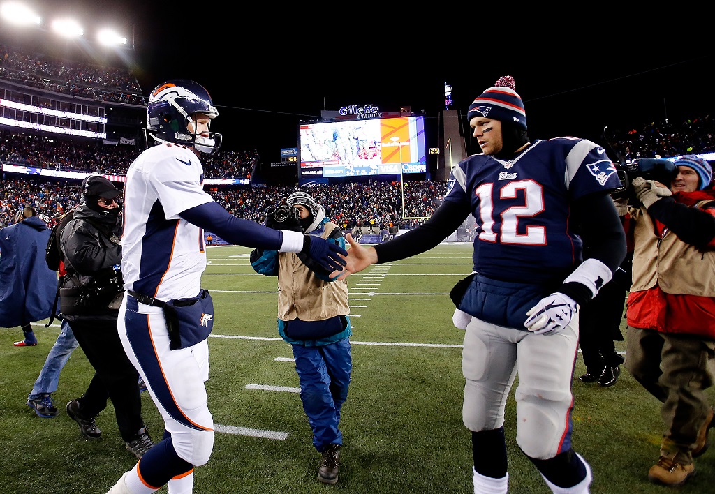 FOXBORO, MA - NOVEMBER 24: Quarterback Peyton Manning #18 of the Denver Broncos and quarterback Tom Brady #12 of the New England Patriots shake hands after the New England Patriots defeated the Denver Broncos 34-31 in overtime at Gillette Stadium on November 24, 2013 in Foxboro, Massachusetts.