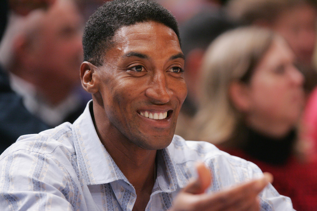 Scottie Pippen smiles as he watches an NBA game courtside.