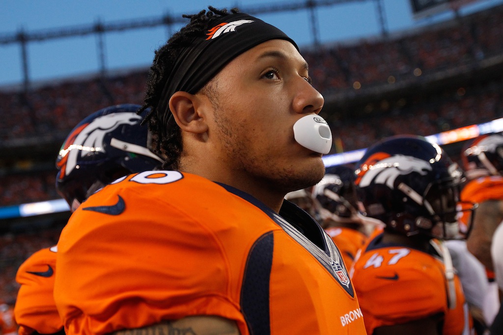 A Denver Broncos play chews bubblegum as he waits for the game to start.