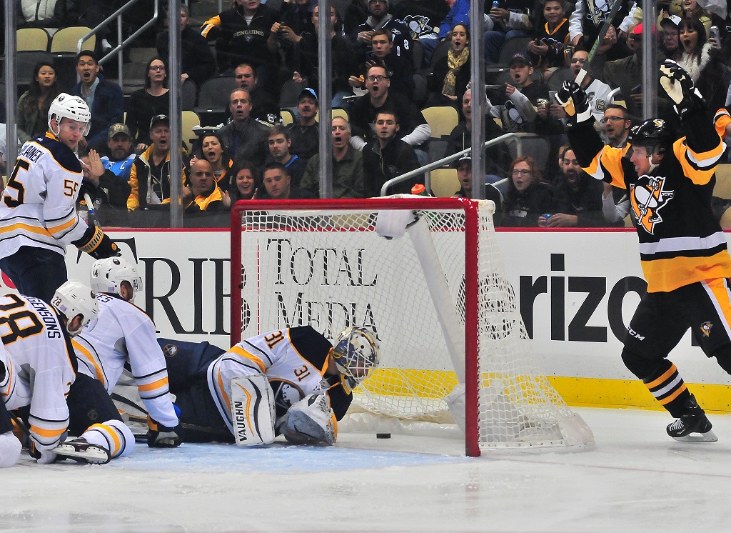 PITTSBURGH, PA - OCTOBER 29: Chad Johnson #31 of the Buffalo Sabres lets the puck into the net as Sidney Crosby #87 of the Pittsburgh Penguins celebrates during the game at Consol Energy Center on October 29, 2015 in Pittsburgh, Pennsylvania.