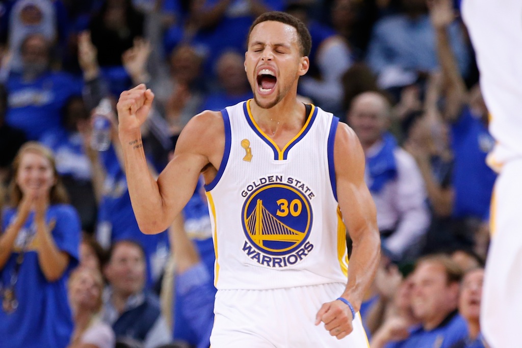 Stephen Curry celebrates a three on opening night