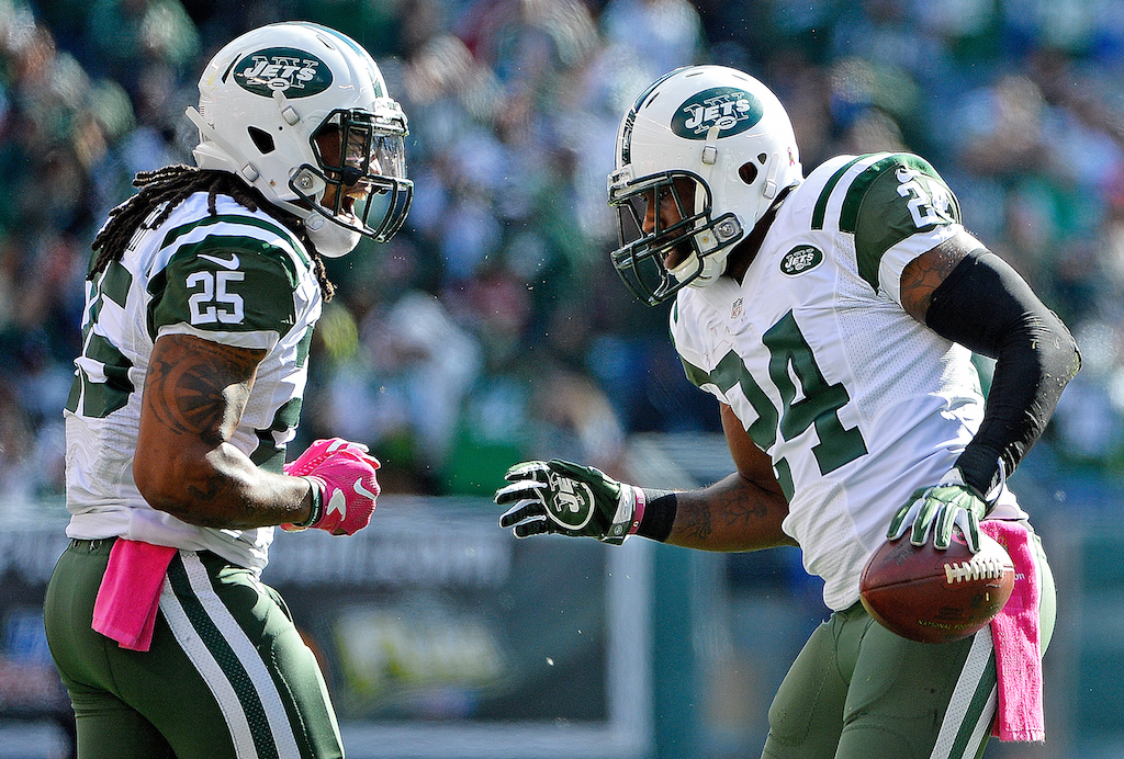 Darrelle Revis of the New York Jets is congratulated by his teammate Calvin Pryor.