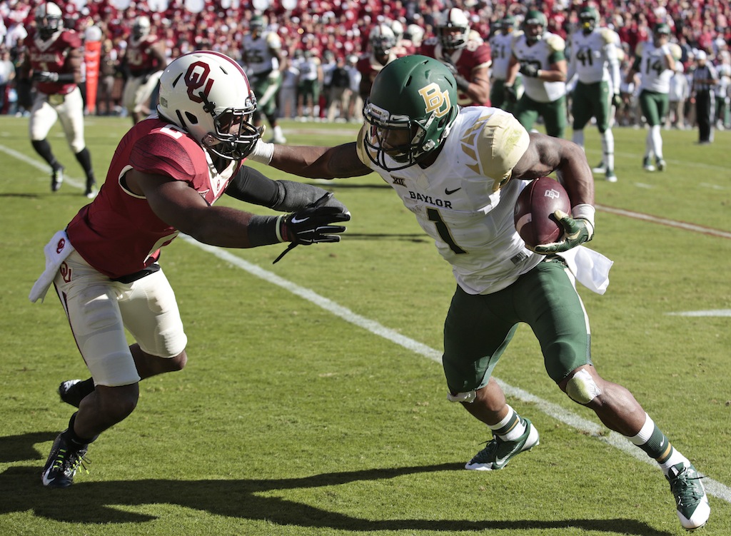 Corey Coleman #1 tries to get by a Sooner defender