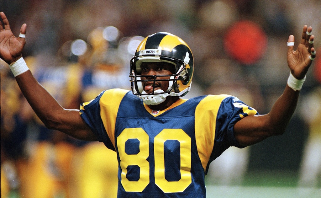 Isaac Bruce stands on the field between plays.