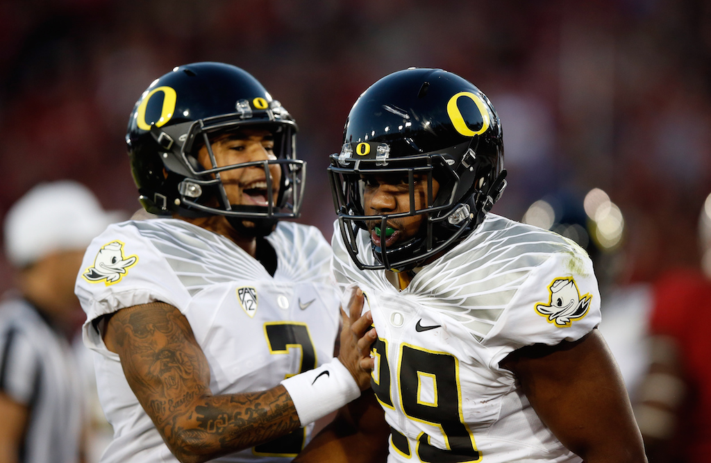 Vernon Adams Jr. #3 congratulates Kani Benoit #29 of the Oregon Ducks after he scored a touchdown