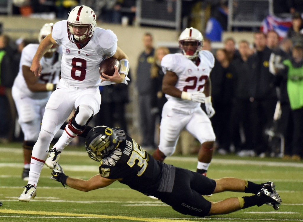 Kevin Hogan #8 runs against Oregon
