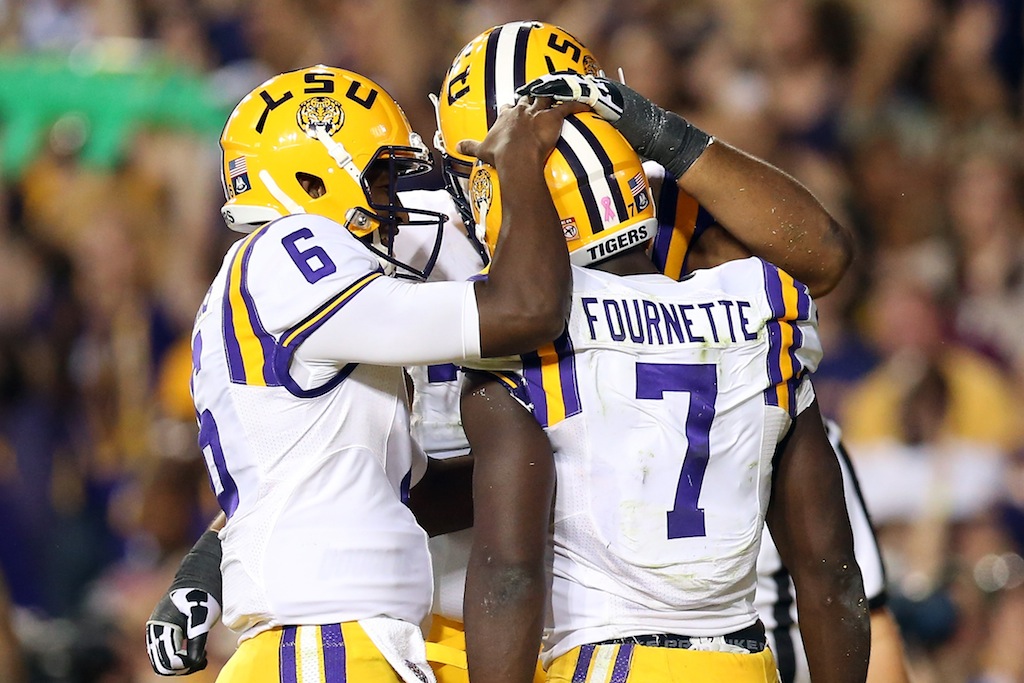 Brandon Harris #6 celebrates with Leonard Fournette #7 of the LSU Tigers after scoring a touchdown