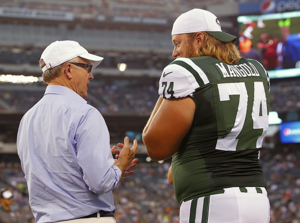 Nick Mangold #74 talks to Jets owner Woody Johnson