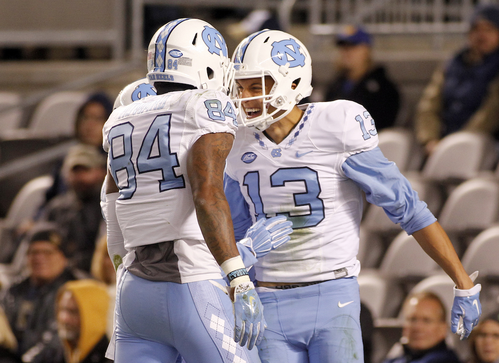 Mack Hollins #13 of the North Carolina Tar Heels celebrates with Bug Howard #84 after catching a 32 yard touchdown pass