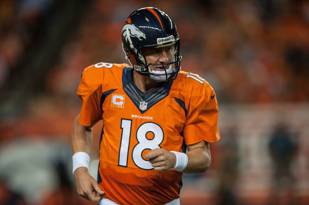 Peyton Manning runs off the field in 2014. 