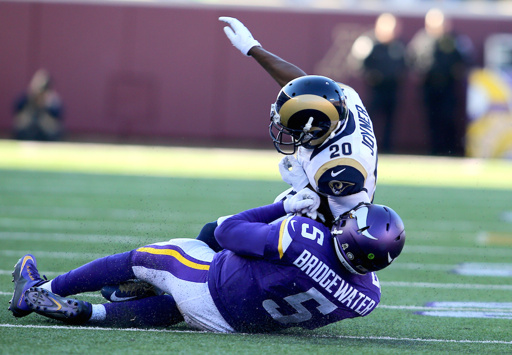Teddy Bridgewater #5 is elbowed as he tries to slide