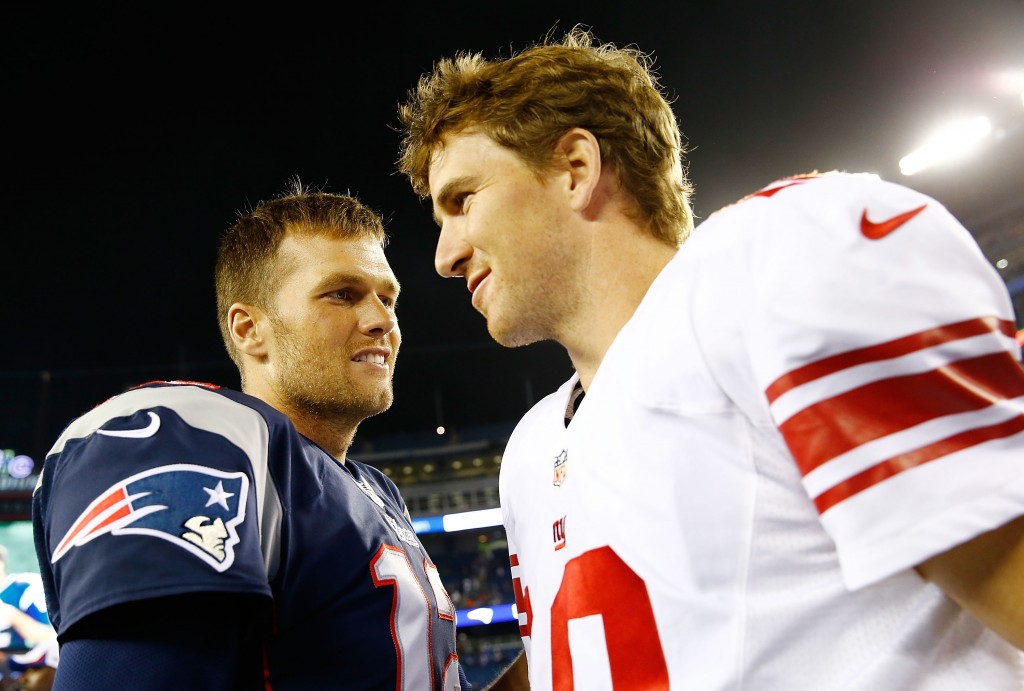 New England QB Tom Brady talks with Giants QB Eli Manning.