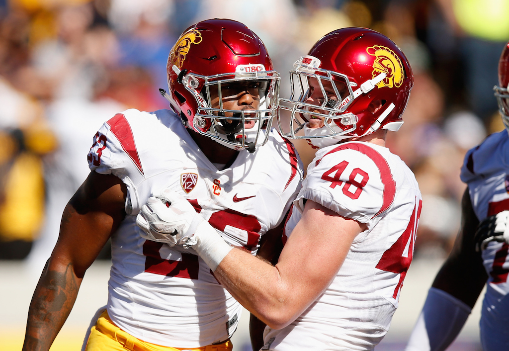Ezra Shaw/Getty Images Tre Madden #23 of the USC Trojans is congratulated by Taylor McNamara #48