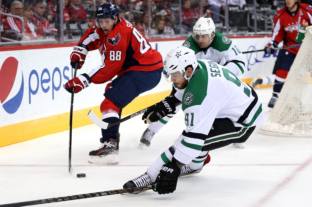 WASHINGTON, DC - NOVEMBER 19: Nate Schmidt #88 of the Washington Capitals skates with the puck as he is defended by Tyler Seguin #91 and Patrick Sharp #10 of the Dallas Stars in the first period at Verizon Center on November 19, 2015 in Washington, DC.