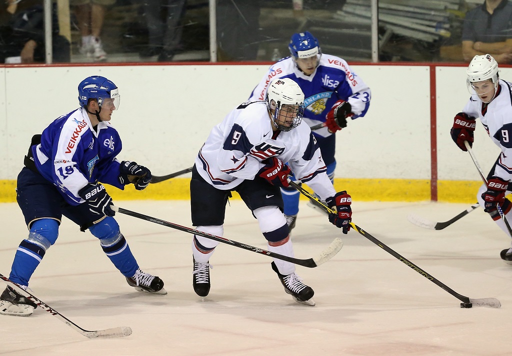 LAKE PLACID, NY - AUGUST 04: Auston Matthews #19 of USA White moves the puck around Saku Kinnunen #18 of Team Finland during the 2014 USA Hockey Junior Evaluation Campat Lake Placid Olympic Center on August 4, 2014 in Lake Placid, New York