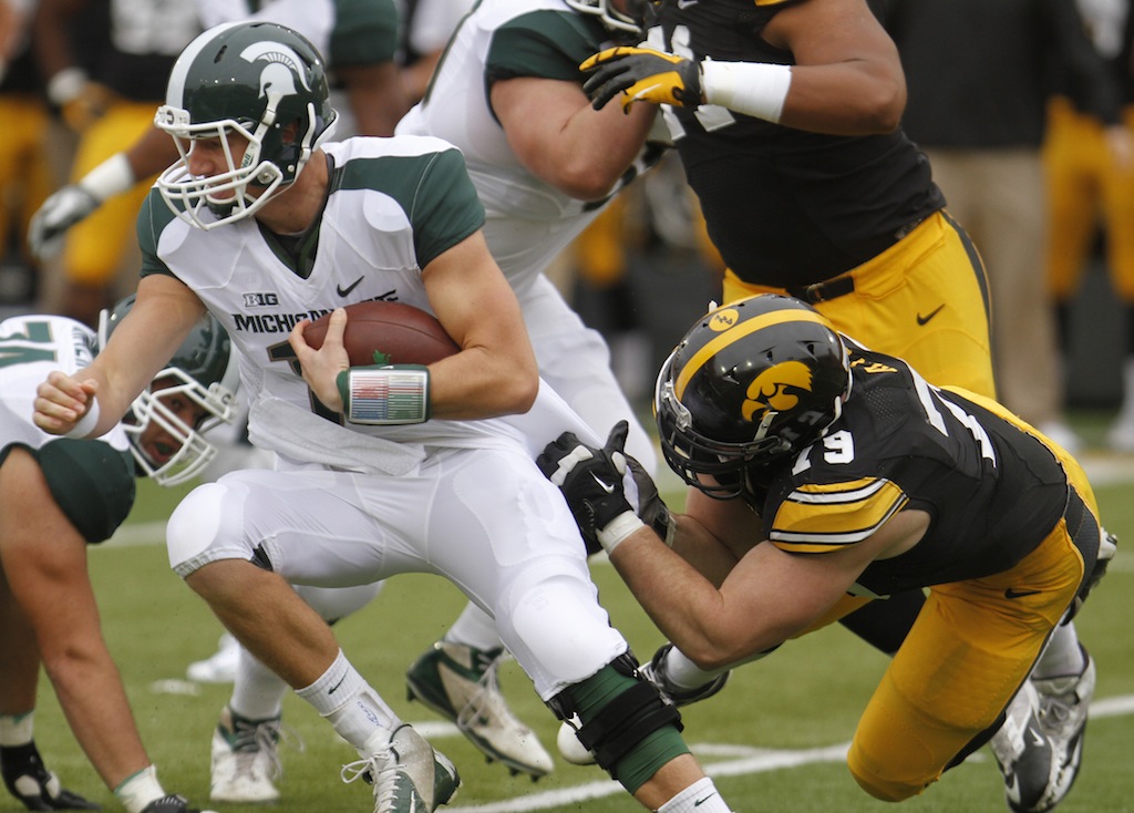 Connor Cook breaks a tackle against Iowa