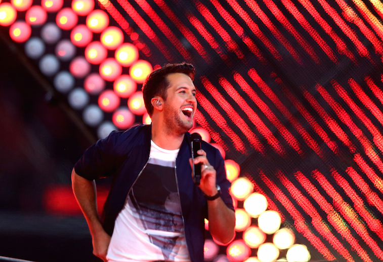 Luke Bryan looks happy as he performs on stage.