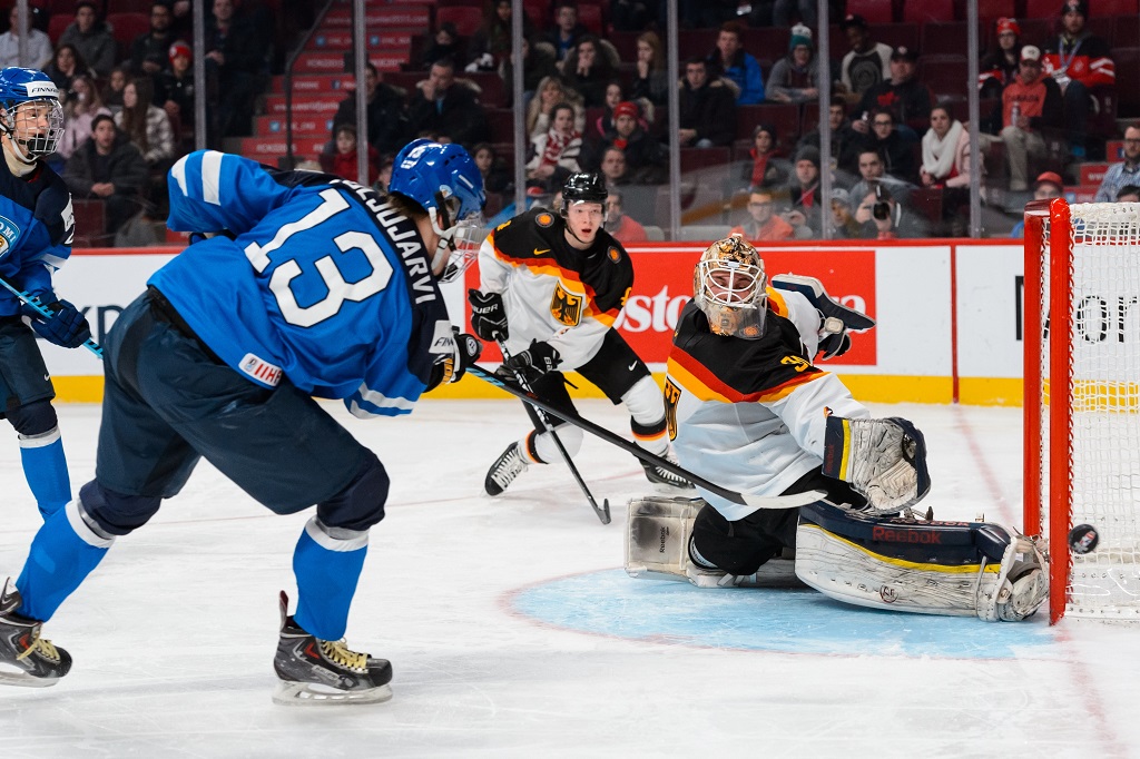 MONTREAL, QC - DECEMBER 31: Kevin Reich #30 of Team Germany stops a shot by Jesse Puljujarvi #13 of Team Finland in a preliminary round game during the 2015 IIHF World Junior Hockey Championships at the Bell Centre on December 31, 2014 in Montreal, Quebec, Canada. Team Finland defeated Team Germany 2-0