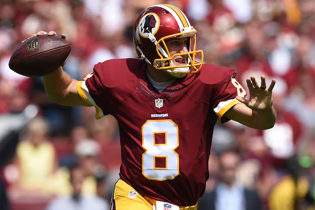 Kirk Cousins grips the football and looks for a receiver.