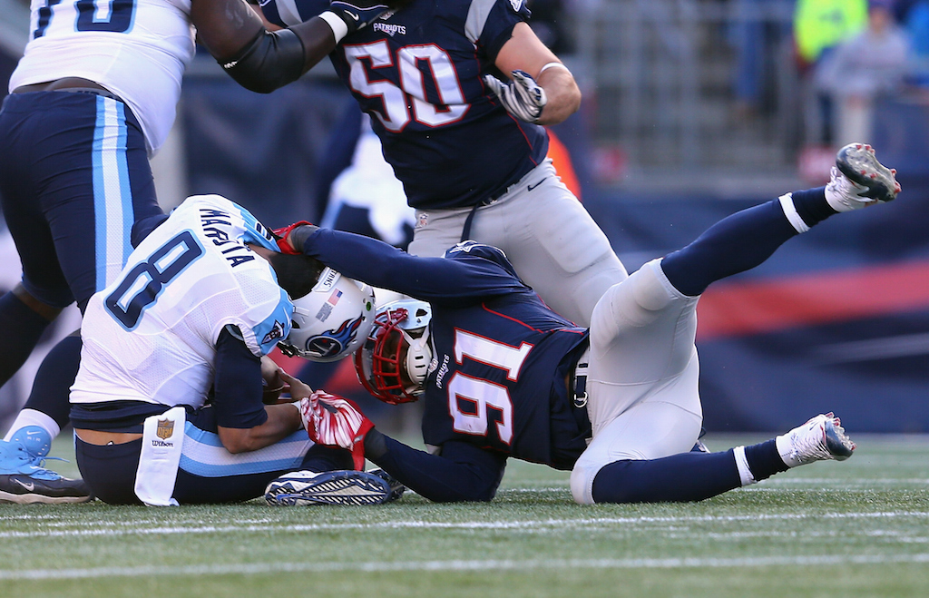 Marcus Mariota is sacked during a game against the Patriots