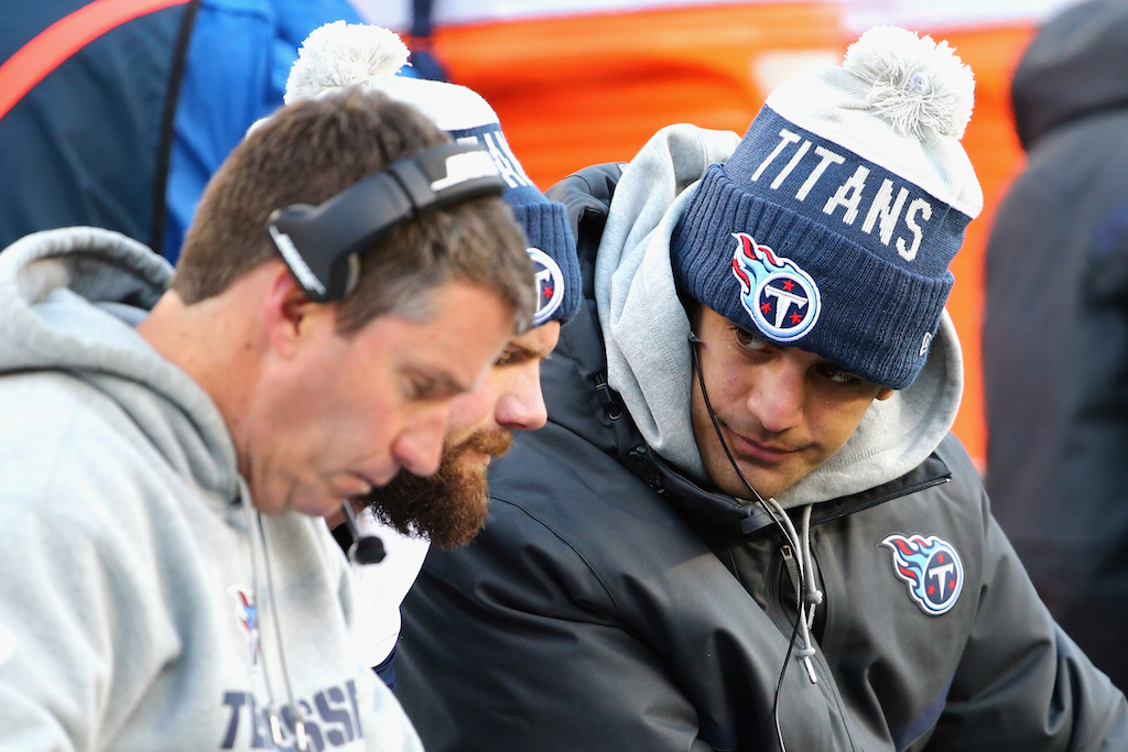Marcus Mariota #8 of the Tennessee Titans (R) sits on the sideline during the game between the New England Patriots and the Tennessee Titans 