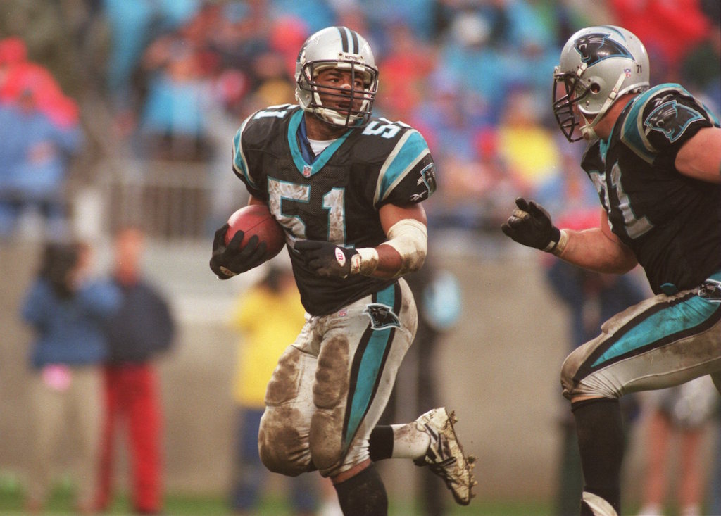 Sam Mills carries the ball after the Panthers force a turnover