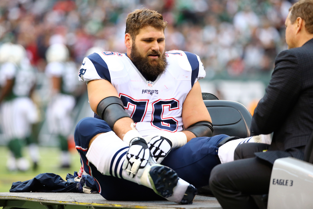 Sebastian Vollmer #76 of the New England Patriots gets carted off the field after being injured
