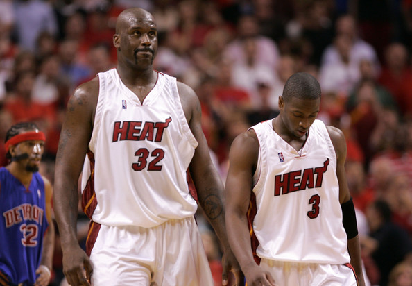 Shaq and Dwyane Wade walk off the court together.