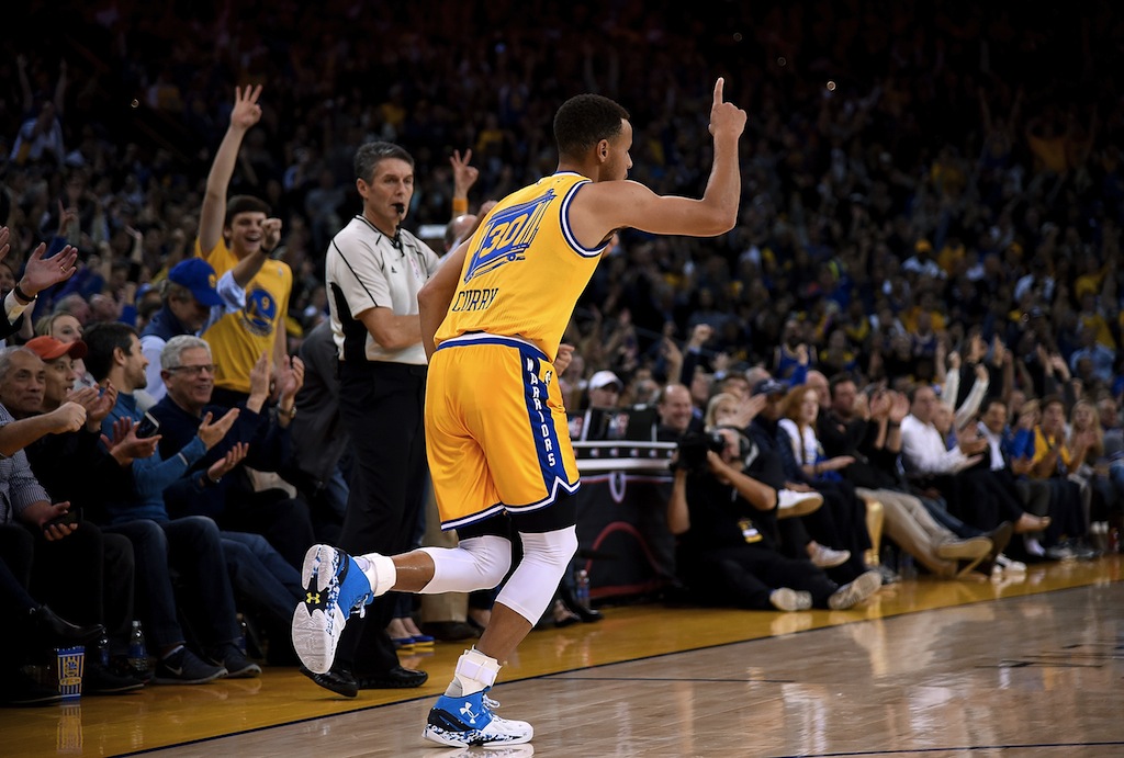 Stephen Curry reacts after hitting a three