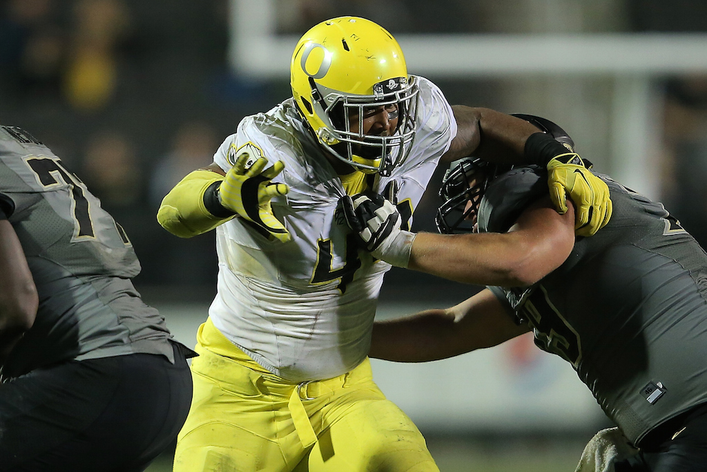 Defensive lineman DeForest Buckner #44 of the Oregon Ducks battle against the Colorado Buffaloes line at Folsom Field