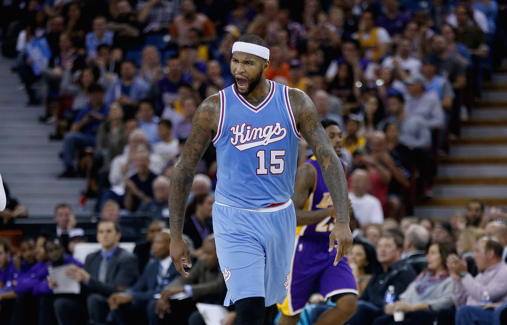 DeMarcus Cousins #15 of the Sacramento Kings reacts after teammates Rajon Rondo #9 made a three-point basket against the Lakers