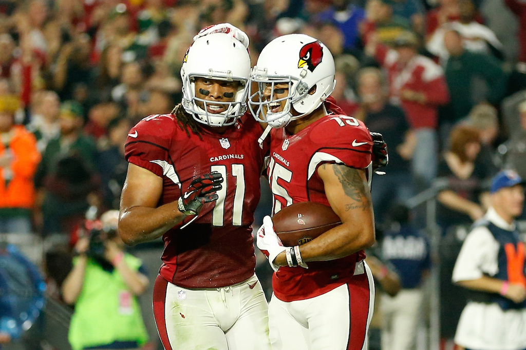 Which NFL players, along with Larry Fitzgerald, have 100 career touchdown receptions?