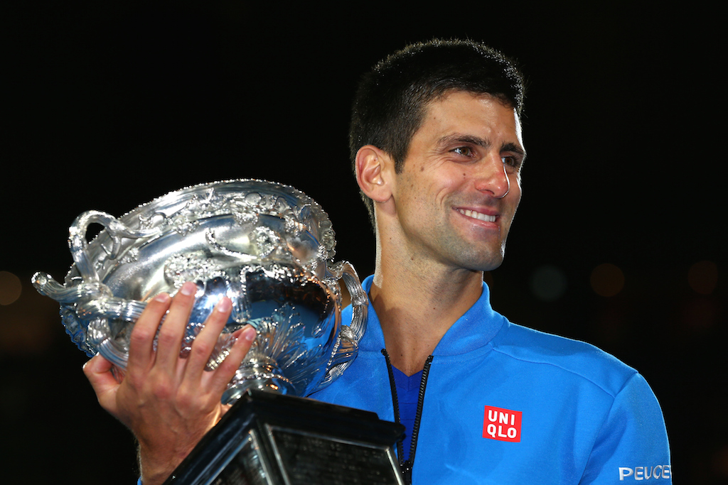 Novak Djokovic of Serbia holds the Norman Brookes Challenge Cup after winning his men's final match