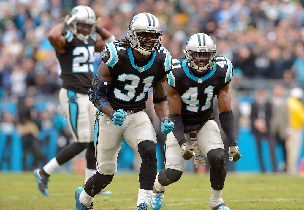 Charles Tillman #31 and Roman Harper #41 of the Carolina Panthers react after forcing a fumble