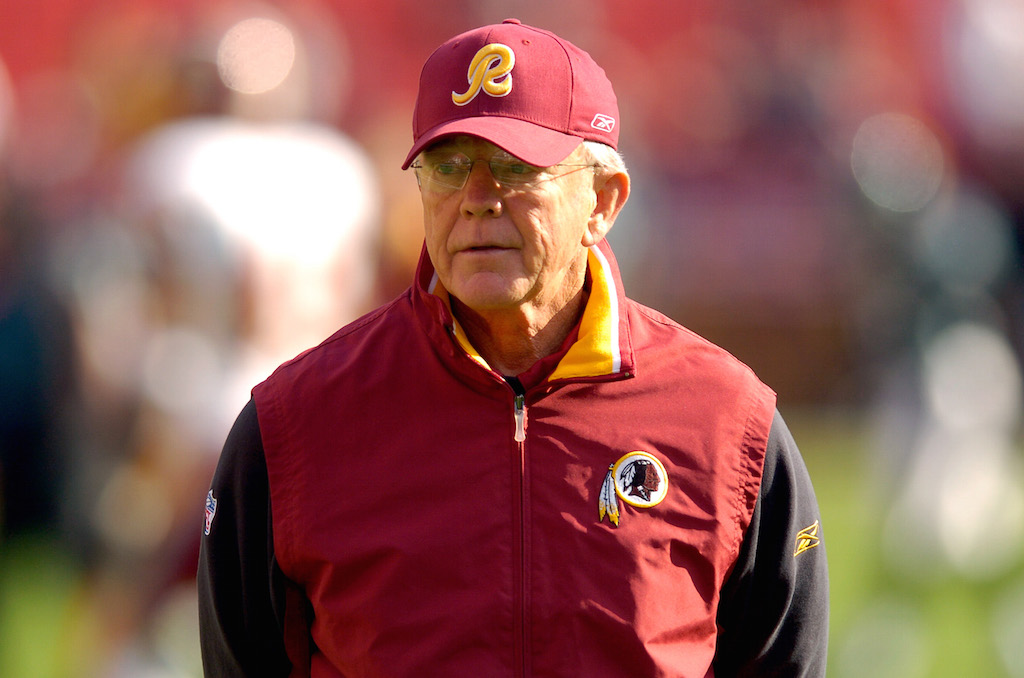 Joe Gibbs watches warm ups before a game against the Eagles