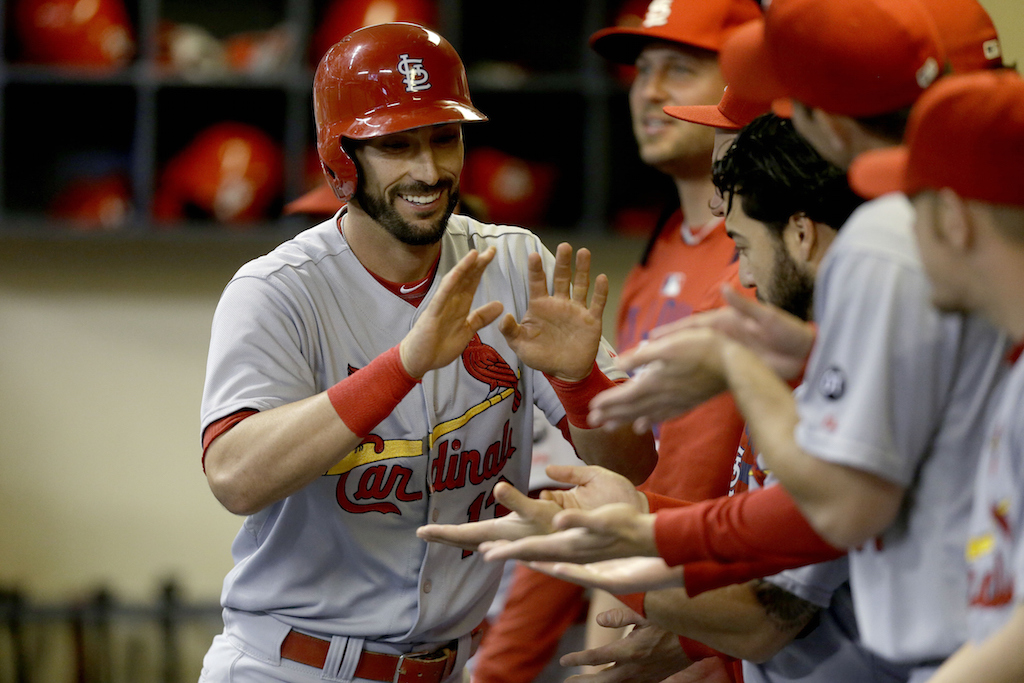 Matt Carpenter #13 of the St. Louis Cardinals celebrates in the dugout after hitting a solo home run