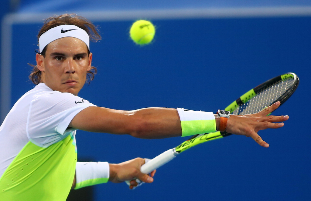 Rafael Nadal returns the ball