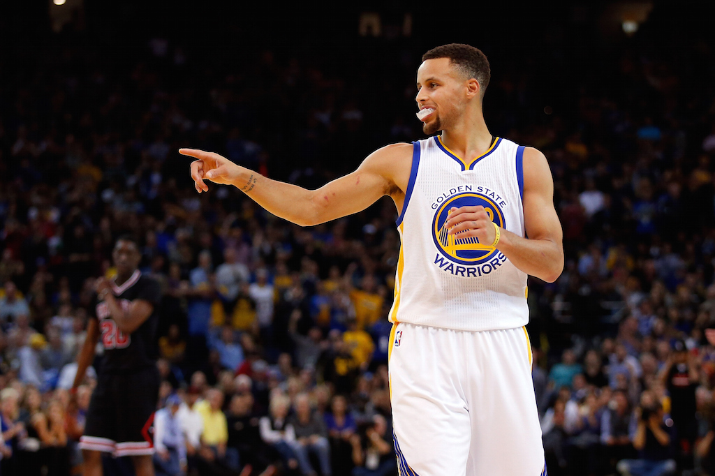 Stephen Curry #30 of the Golden State Warriors points to his teammates
