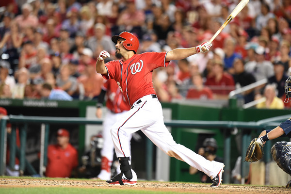 Anthony Rendon watches the ball fly out of the stadium after he makes contact.
