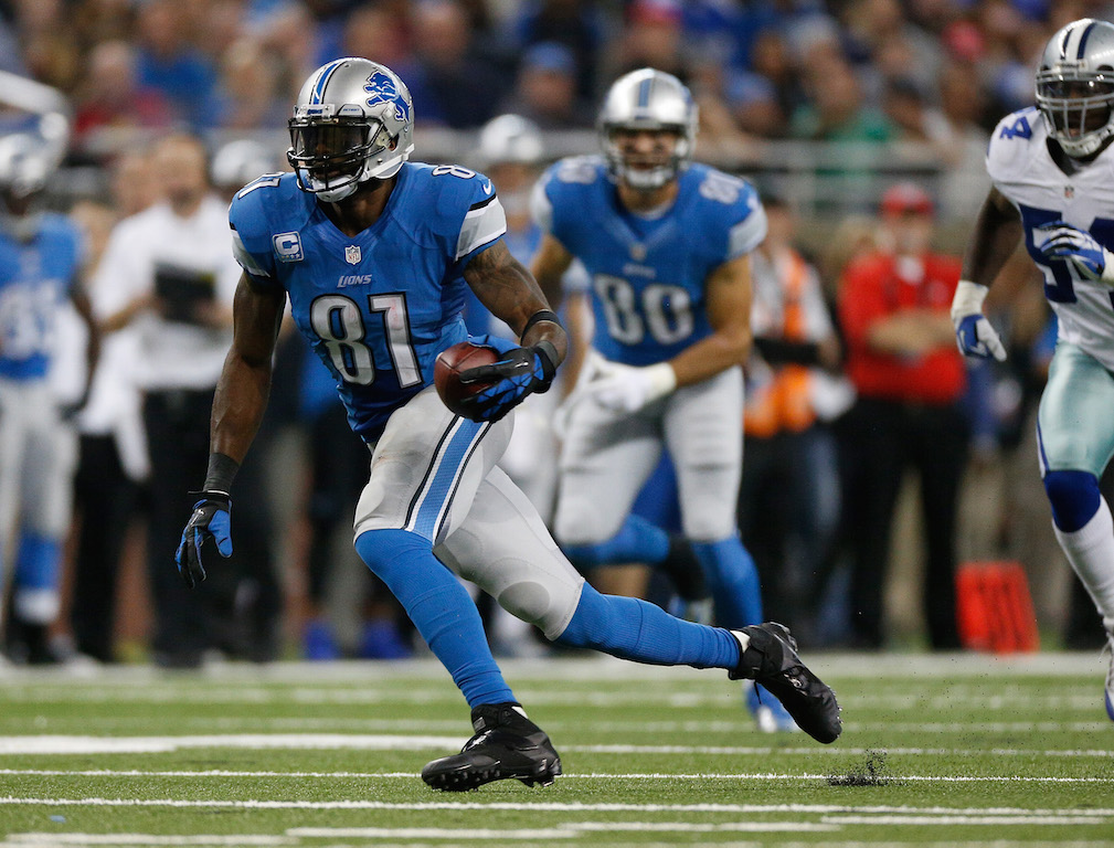 Calvin Johnson #81 of the Detroit Lions runs for extra yards after a third quarter catch while playing the Dallas Cowboys