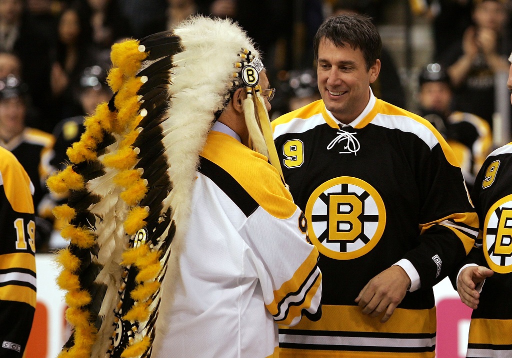 BOSTON - FEBRUARY 13: Former Bruin player John "the Chief" Bucyk shakes hands with Cam Neely as Bucyk was honored for his fifty years with the Boston Bruins organization before the game between the Edmonton Oilers and the Boston Bruins on February 13, 2007 at the TD Banknorth Garden in Boston, Massachusetts. (Photo by Elsa/Getty Images)