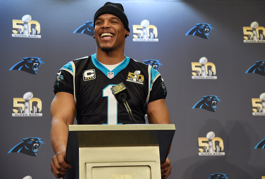 Cam Newton smiles during a pre Super Bowl press conference.