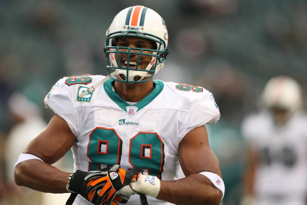Jason Taylor smiles as he adjusts his gloves.