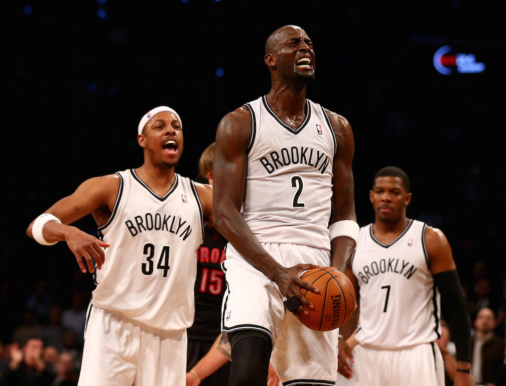 Paul Pierce, Kevin Garnett, and Joe Johnson react to a play.