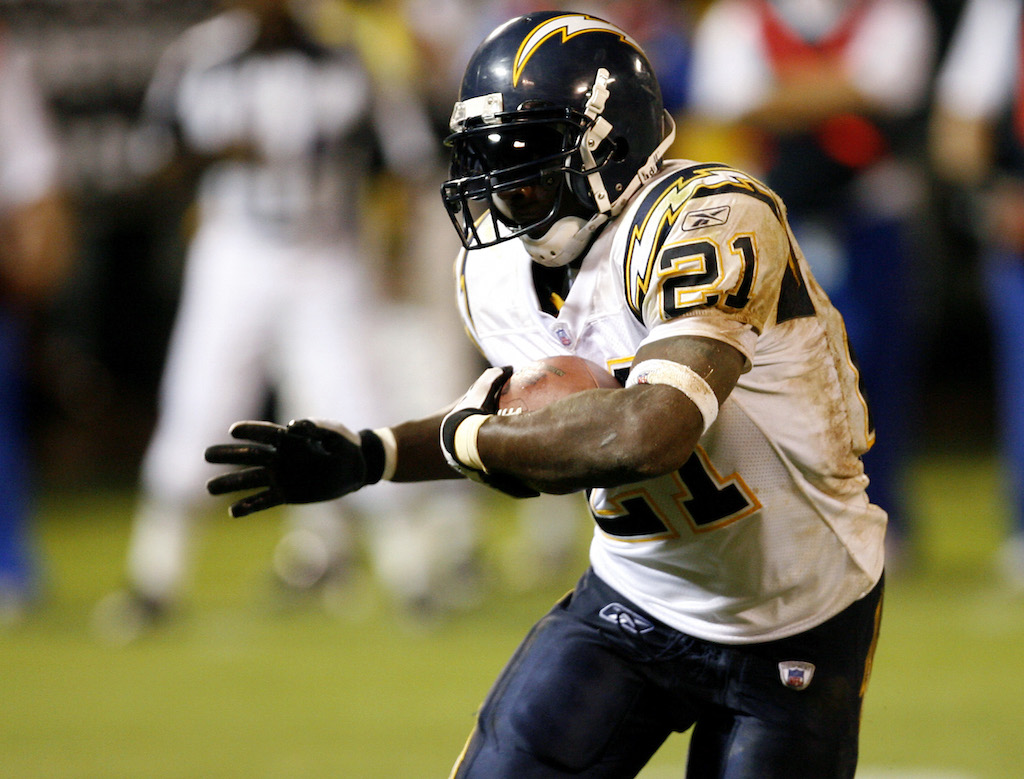LaDainian Tomlinson tucks in the ball and makes a run for it.