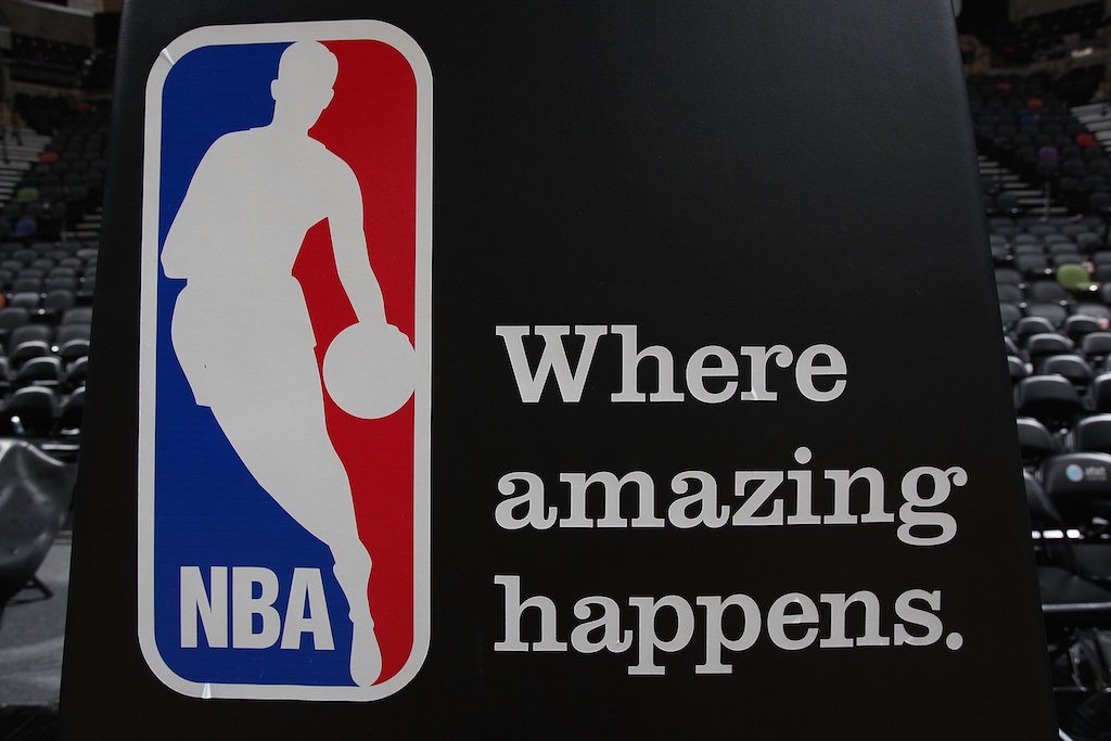 A basketball court shows off an NBA logo.