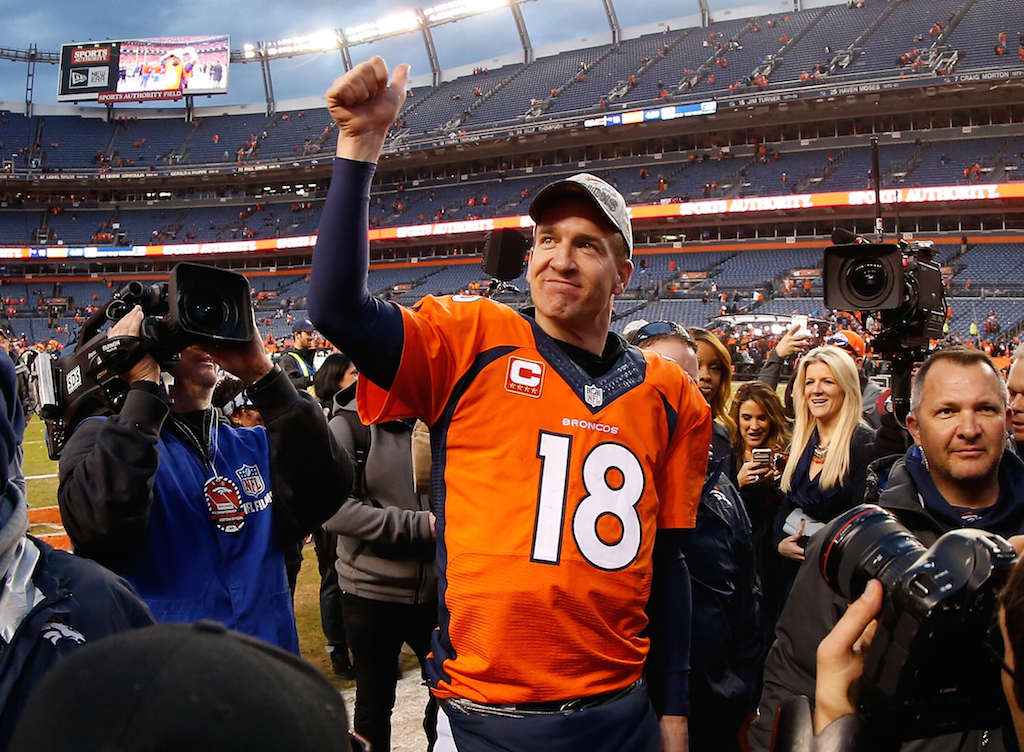 Peyton Manning #18 of the Denver Broncos walks off the field after defeating the New England Patriots in the AFC Championship game 